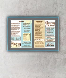 Menu SwingFrame with Turquoise Frame with Gray Mat Against Gray Concrete Wall