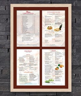 Menu SwingFrame with Natural Clear Wood Frame and Dark Red Mat Against Dark Brick Wall