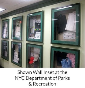 SwingFrame Display Case with Fabric over Cork Board. Shown installed inset with Green Wood Moulding and Green Matboard at NYC Parks and Recreation.